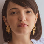 Aretes Hoja Pino Grande en bronce bañado en oro de 24k, destacando la belleza natural de las hojas de pino inmortalizadas