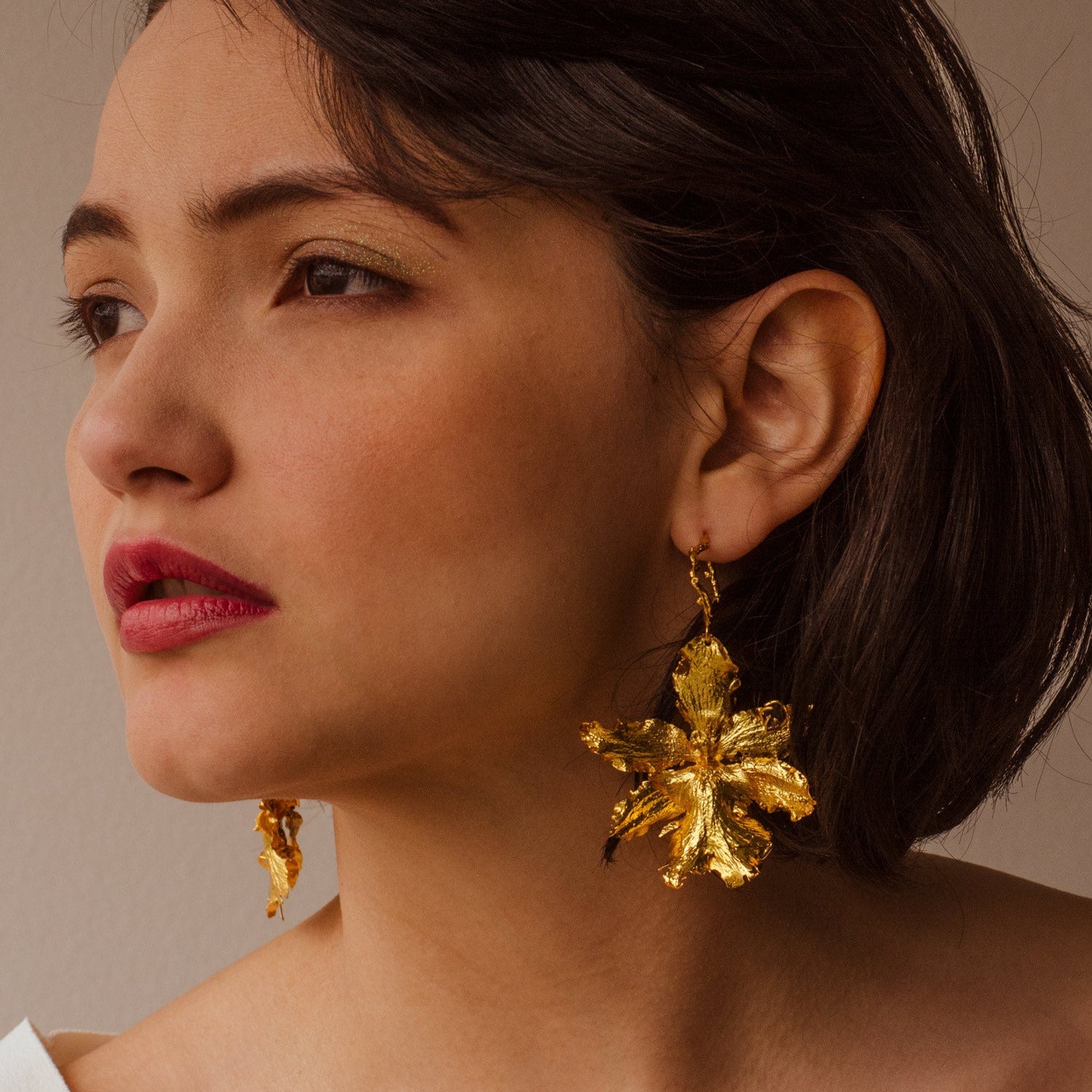 Modelo con Aretes Aro Orquidea Odontoglossum natural inmortalizado en bronce con cuarzos naturales